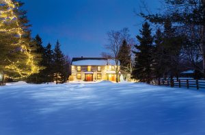 A winter’s night at the log home built by an early settler in Grey County in the mid-1800s. The two-storey extension and carport were added by the current owners.