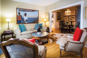 Dominating the small, formal living room of this century home is a dramatic oil, “Balancing,” by Canadian artist Paul Fenniak. Art books are stacked everywhere throughout the house.