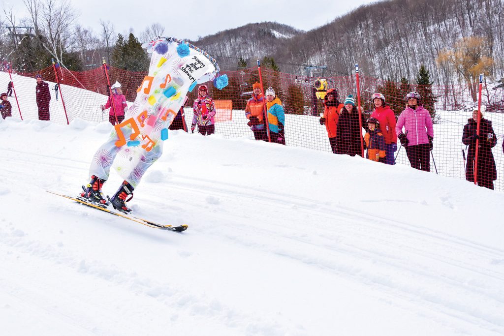 Alpine’s Festival Day culminates in a downhill dummy race (above), where ski dummies constructed and decorated by members are sent down a short racecourse that ends with a jump.