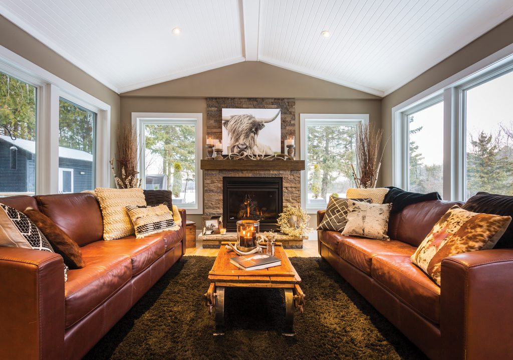 The family room off the back of the house was originally a screened-in porch. Fireplace stone by Maxwell Stone, Feversham. Sofa cushions by Dovetail Interiors.