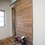 The same fumed oak as the floorboards was used to make sliding barn doors for the bedroom cupboards. Carpenter Travis Cuff of T.T.C. Carpentry came up with the idea of using old wooden skis as handles.