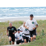 Running in a group offers many advantages over running alone. Members of the GTRC (pictured running up from Wasaga Beach) say they enjoy the social aspect and the motivation of training with like-minded individuals. Other perks of belonging to the club include special discounts on shoes, GPS equipment and other gear.