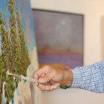 Bill Franks, one of the artists at The Tremont, puts brush to canvas on one of his paintings. Franks, who was influenced and taught by A.Y. Jackson, has travelled from one coast of Canada to the other, plus five trips to the High Arctic. His paintings hang in private collections across Canada and internationally.