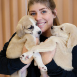 Kayla Campbell with two of six puppies from the same litter who arrived at the shelter*. “This is a happy place,” she says. “All of the volunteers are here because we love animals. We take very good care of them, and we’re always thrilled to see them find good homes.”