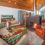 Bright colours warm the sitting area. The two-sided fireplace, from Belgium, has a pre-rusted finish of Corten steel.