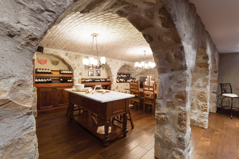 This man cave, dubbed “the grotto” by the homeowner, was designed to mimic an authentic Italian restaurant, including stone arches, vaulted ceilings, pizza oven and marble prep table.