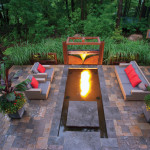 With new technology, both fire and water can be incorporated into the landscape. Here, the fire comes from a gas line beneath the water’s surface, creating a warming glow on summer evenings.