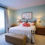 The master bedroom is painted a soothing pale blue, while thick broadloom gives the room a luxurious feel.