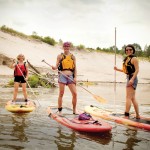 Jennie Elmslie of Free Spirit Tours (left) gives a SUP lesson to Pam Paylor (centre) and Sonya Reiner.
