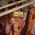 Cured smoked chops hang in the smoker at Hoffman’s Meats and European Deli in Stayner.
