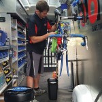Tim Carter, a mechanic for Velofix Collingwood, repairs a bike in the Mercedes Sprinter van Velofix has customized into a complete mobile bike pro shop.
