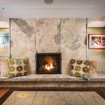 The massive stone slabs in the lower-level fireplace came from the quarry at Maxwell Stone. Stone mason John Davies of Meaford installed them. The carpet is from Modern Weave.