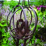 Headford loves sculpture and has placed many throughout the property. This iron globe sits amid clumps of Clary sage in the medicinal herb garden.