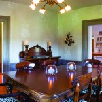 In the dining room, family heirloom furniture looks at home with the newly painted wainscoting and mouldings. The walls were painted and stenciled by Beth Halstead. Over the table is a light fixture from Bellhaven Antiques in Creemore.
