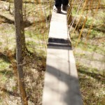It’s one foot in front of the other along the treetop canopy walk, a two-by-10-inch wooden plank supported by ropes.