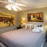One of several guest rooms used for visiting family and friends features a cow painting found in a nearby barn and cleaned up. Resting on the bed is Morrissey’s rescue dog, Odie.