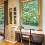 At one end of the kitchen is a convenient built-in hutch and a desk with a view of the woods. Desk chair from Hollace Cluny.
