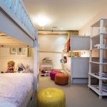 Five-year-old twin girls share a bedroom, which has two sets of bunk beds for sleepovers with friends.