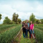 Kimberly and Tim Schneider and daughter Teaghen among the garlic crop at Dunridge Farms.