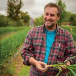 Tim Schneider says leaving the stalks on the bulbs improves the flavour of the garlic while attesting that Dunridge Farms garlic is grown locally and organically.
