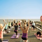 Practitioners take a yoga class on the Thornbury Pier.