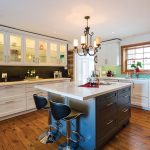 The old kitchen was gutted and renovated to include new flooring (made to resemble weathered pine) and a new island with quartz countertop. Marie-Claude used blackboard paint for one wall to contrast with the white cabinetry