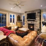 The family room was renovated with all new windows and doors and the fireplace converted from wood-burning to gas. The durable leather sofa is from Restoration Hardware.