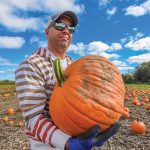 Janse DiFruscia harvests a pumpkin