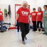 Janet Norman (centre, above), participates in hopscotch during a Peer Health Initiative class at the Orthopaedic Sport Institute as Jim O’Brien (back left) Susan Spencer, Denise Cormier and Dr. Olivia Cheng look on.