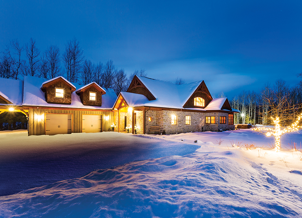 The house sits on a secluded three-acre lot. Night lights add wintry sparkle to the property, which includes a pump track for snowboard training.