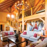 In the open concept living space, works of art fill the spaces between the timber frames.