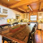 Reclaimed pine floors, leathered granite countertops and a stone backsplash add rustic ambiance to the kitchen