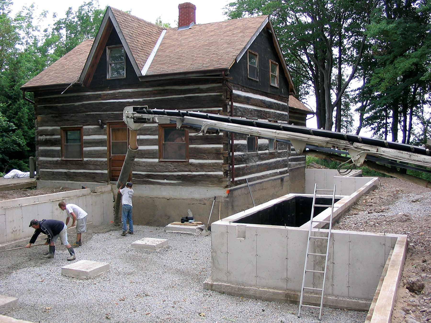 Photos taken during construction show the footprint of the original log cabin (actually two cabins joined together) and the additions Van Strien built around it.