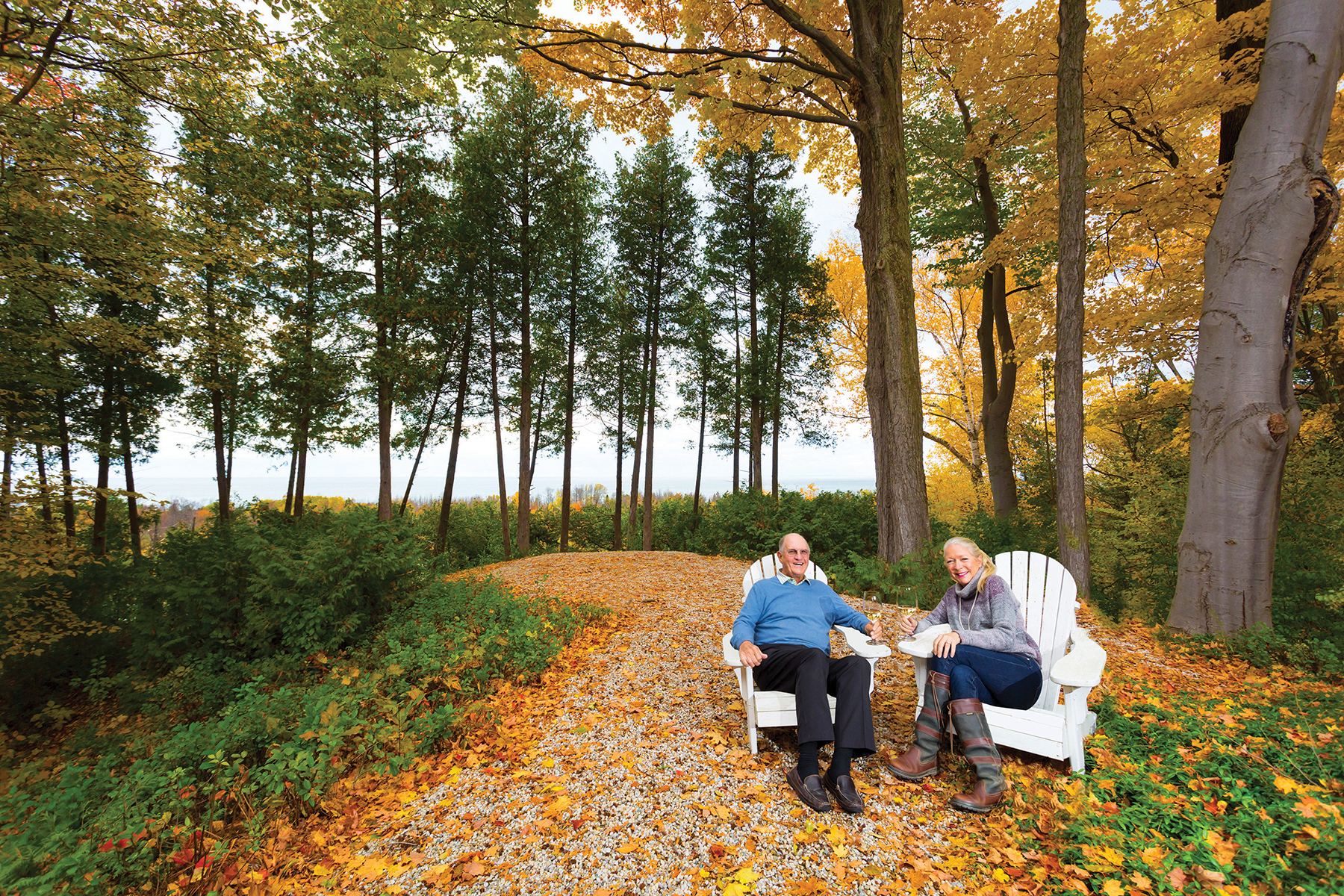 Homeowners Susan and Stuart Ash sit on the promontory that looks out over the Escarpment to the Bay.