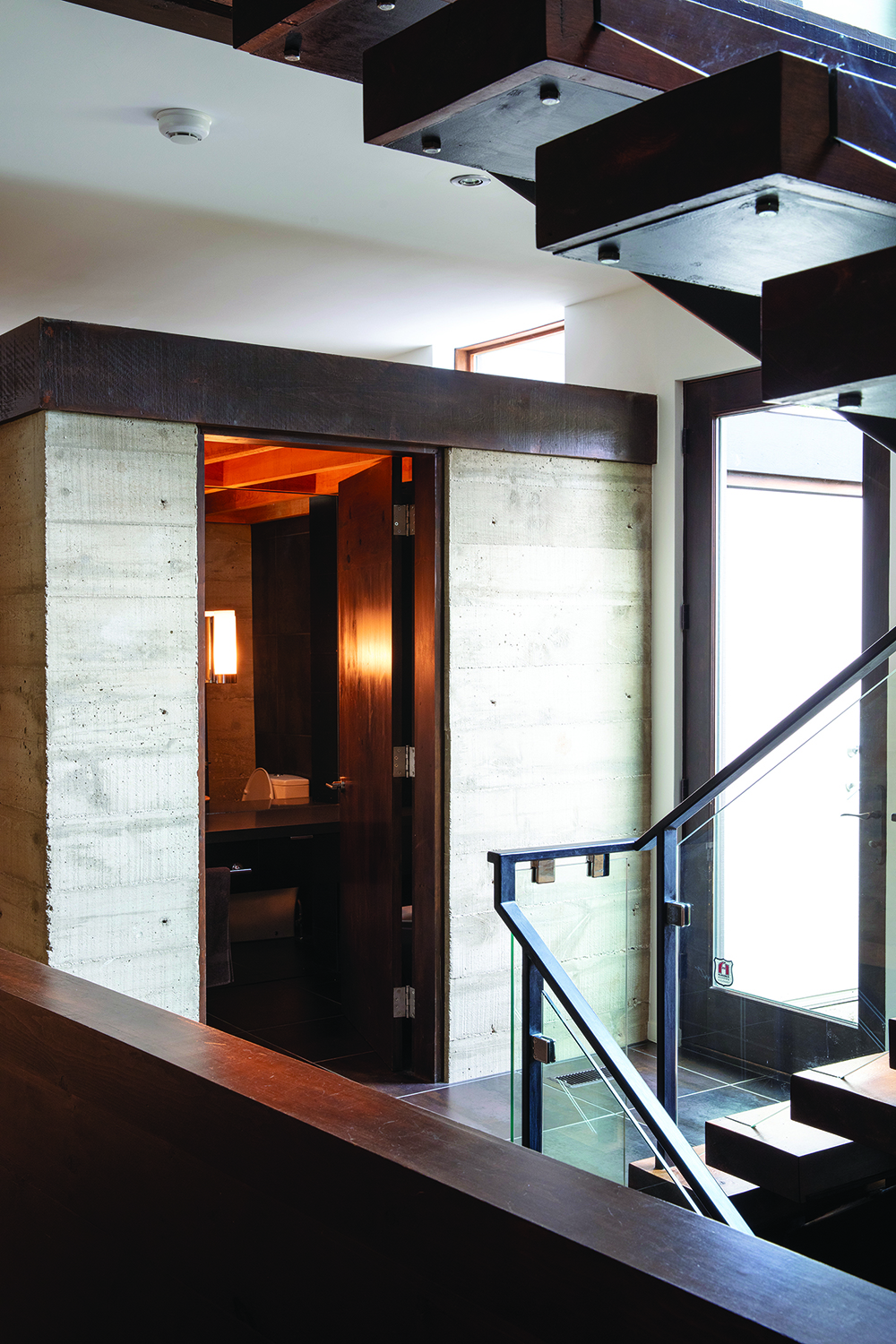 The main-floor powder room sits in a boarded concrete block with open space above.