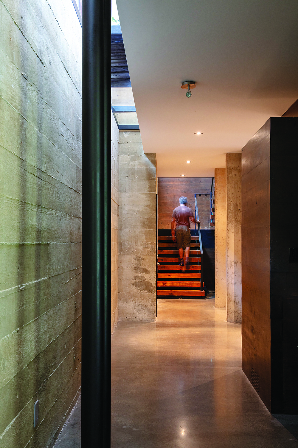 In the hallway, walls are slightly diagonal to create a feeling of walking through the crevices and caves of the Escarpment.