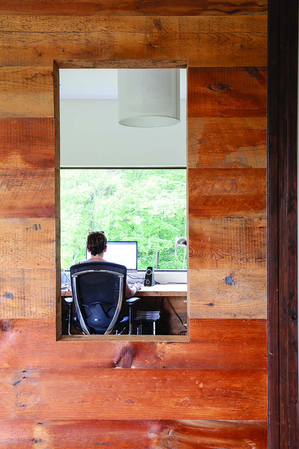 Homeowner Helen Thomson loves working in her cosy loft office space on the top floor, with windows providing views to both the outside and the inside.