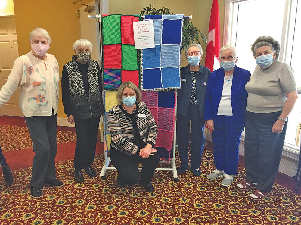 General Manager Jodi Napper-Campbell (kneeling) with residents of Waterford Barrie.