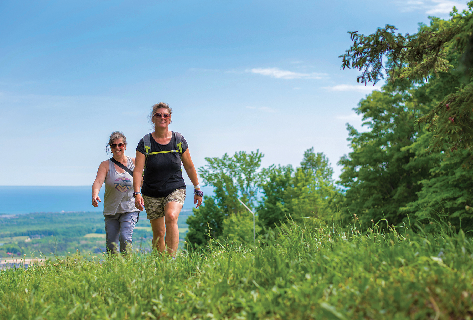 Susan Brindisi (at left) and Cherie Wilson hike The Grind at Blue Mountain Resort, one of 21 hiking and multi-use trails of varying degrees of difficulty open for hikers who have purchased a day pass or have a 5x7 or Ikon season pass for the 2021 season.