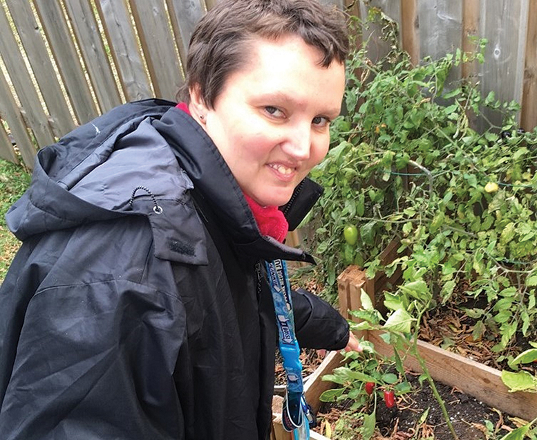 Client Stephanie works in the Breaking Down Barriers garden.