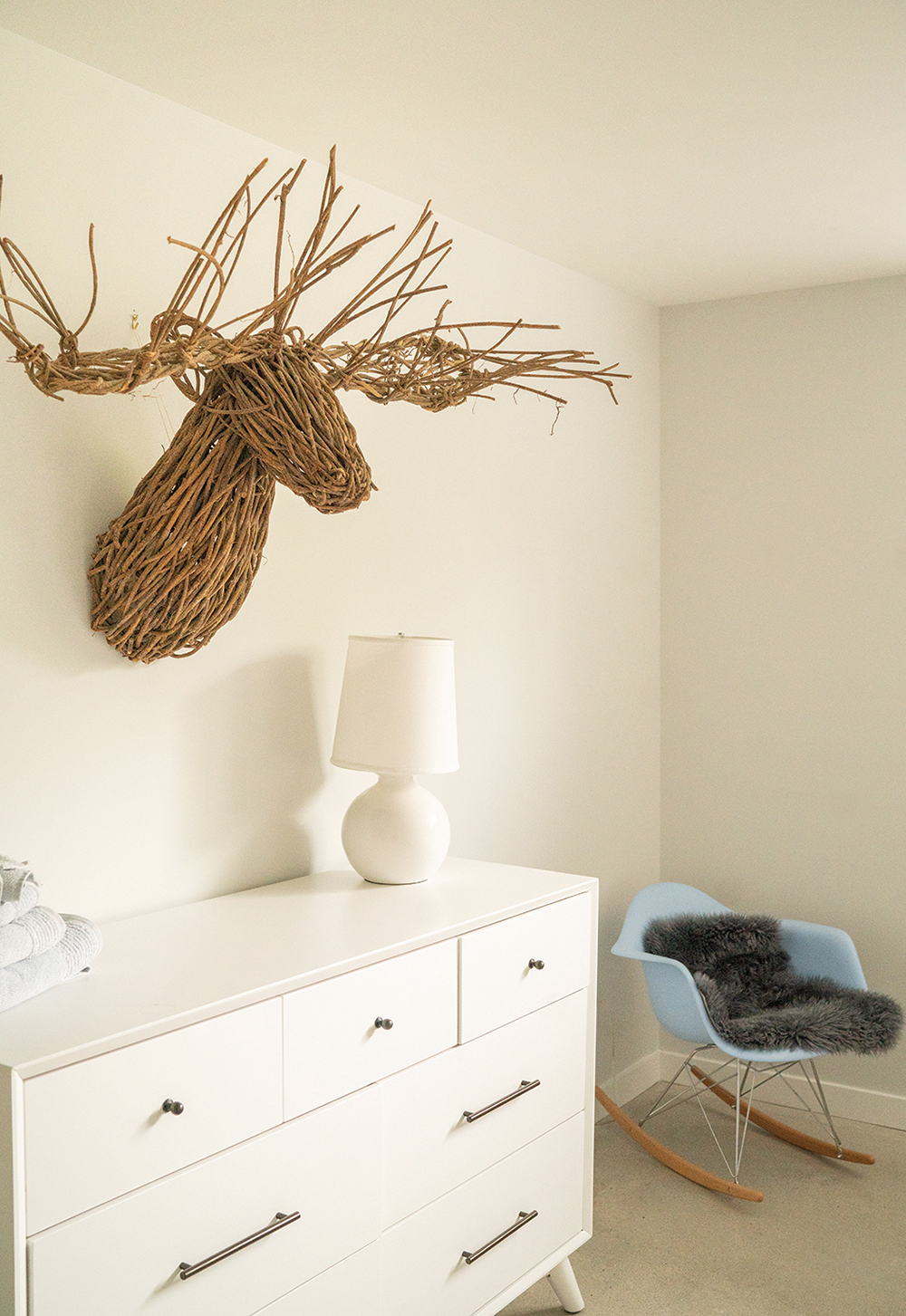 Moose: A twig wall sculpture adds a whimsical touch in a guest bedroom.