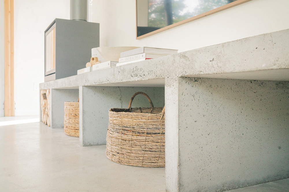 Polished concrete supports both the modern feel, and the fireplace/woodstove (from The Fireplace Stop) to code-height above the floor.