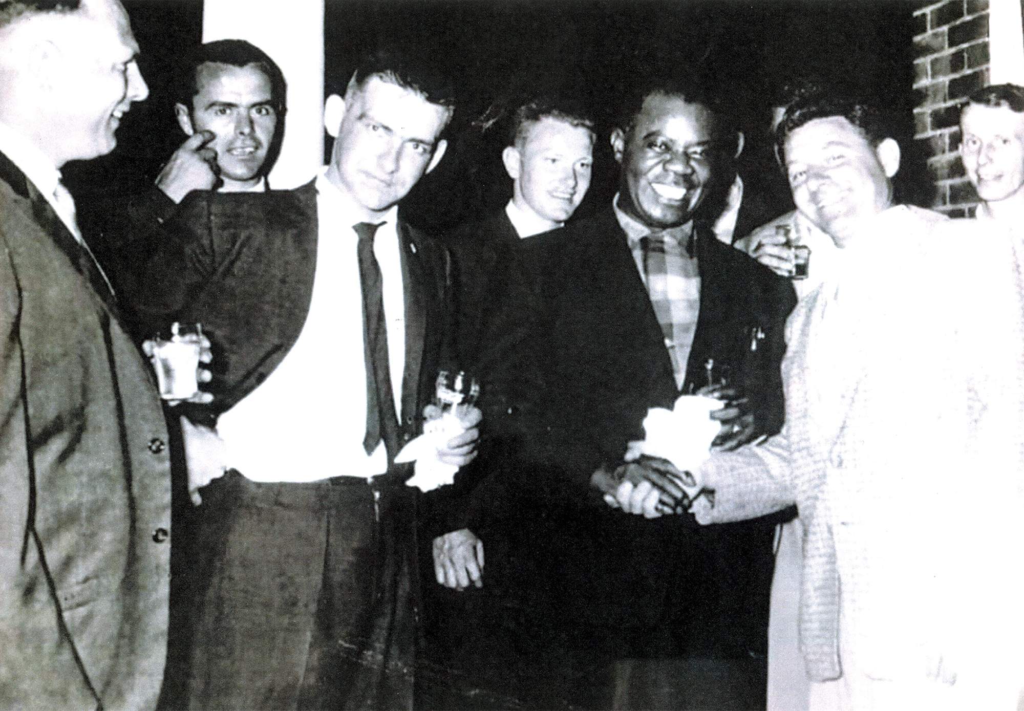 Louis Armstrong in Collingwood. Left to right: unknown, unknown, Buddy Brown, Roger Lockhart, Louis Armstrong, Sam Prezio, John Scheffer.