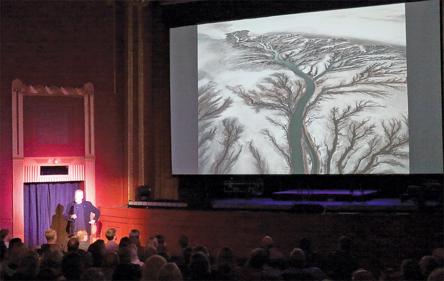 Edward Burtynsky presenting with a photo of the Colorado River.