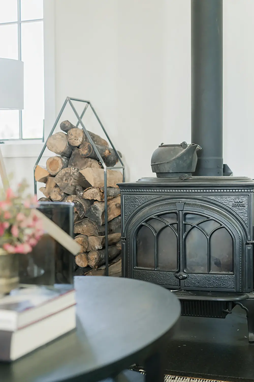 The light-filled entrance hall features antique closet doors from The Door Store. The wood-burning stove was salvaged from the schoolhouse and refinished.