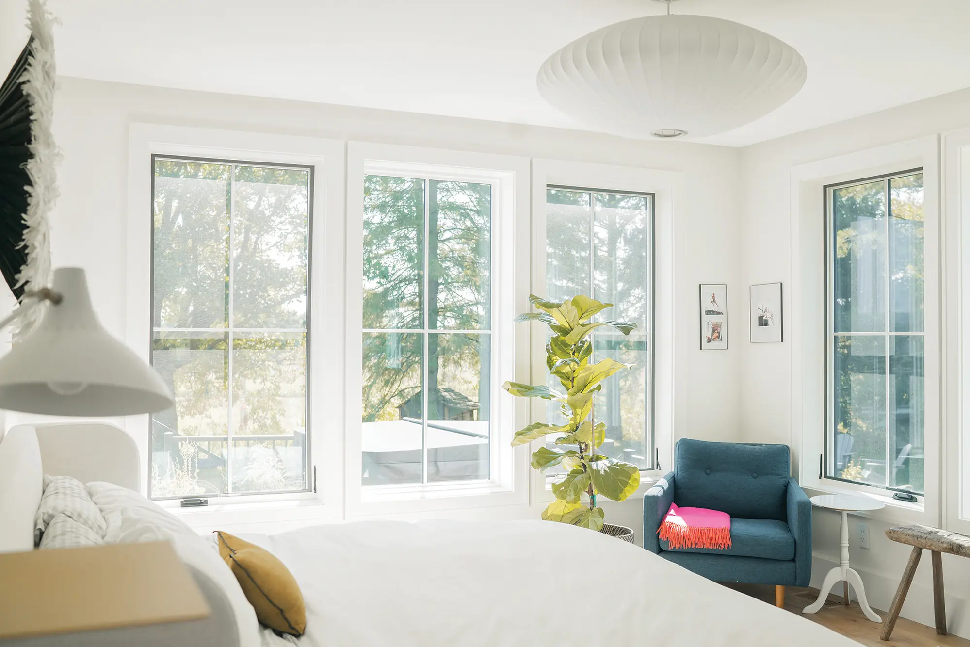 Light fills the main floor primary bedroom. Blue jay wallpaper by Kate Golding from Memo showroom accents the boys’ room.