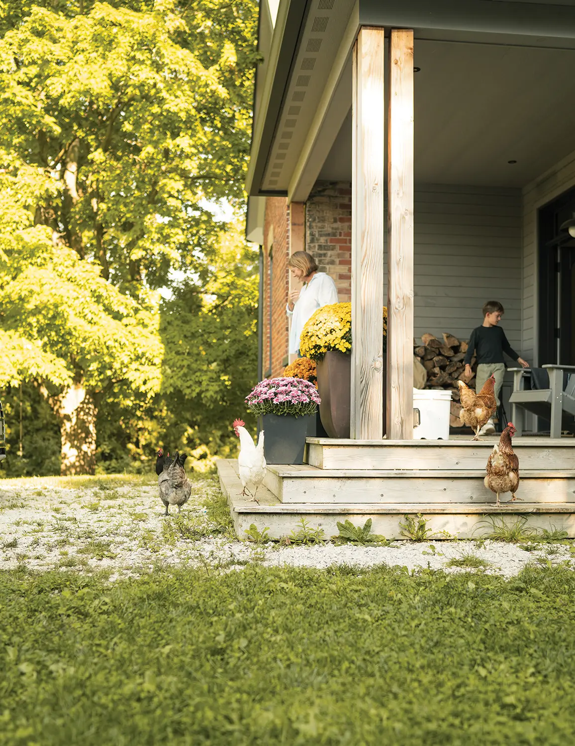 The spacious front porch overlooks Ashley’s huge fenced garden where she has a flower cutting bed and grows veggies, as well as a separate coop housing nine chickens.