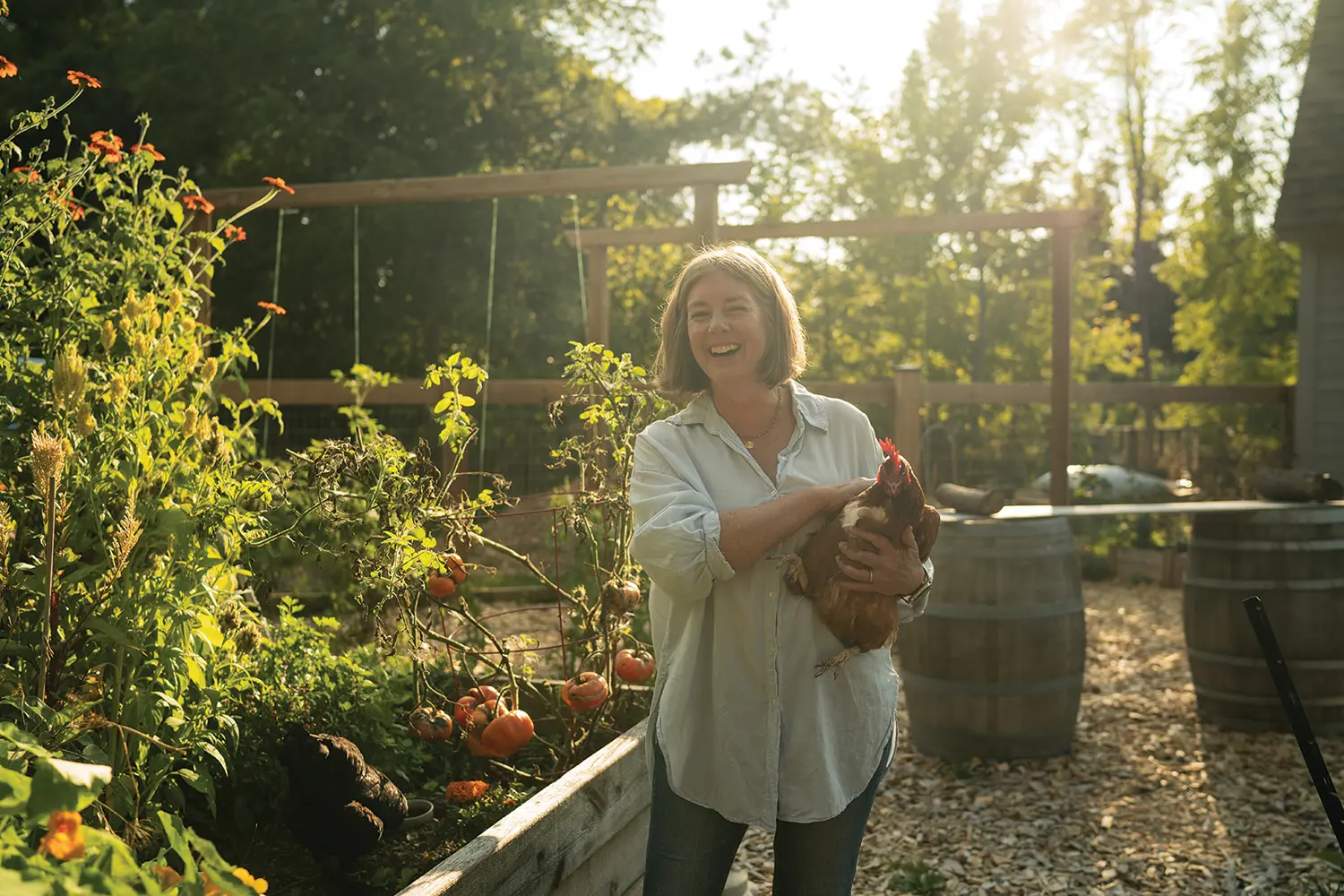 The spacious front porch overlooks Ashley’s huge fenced garden where she has a flower cutting bed and grows veggies, as well as a separate coop housing nine chickens.