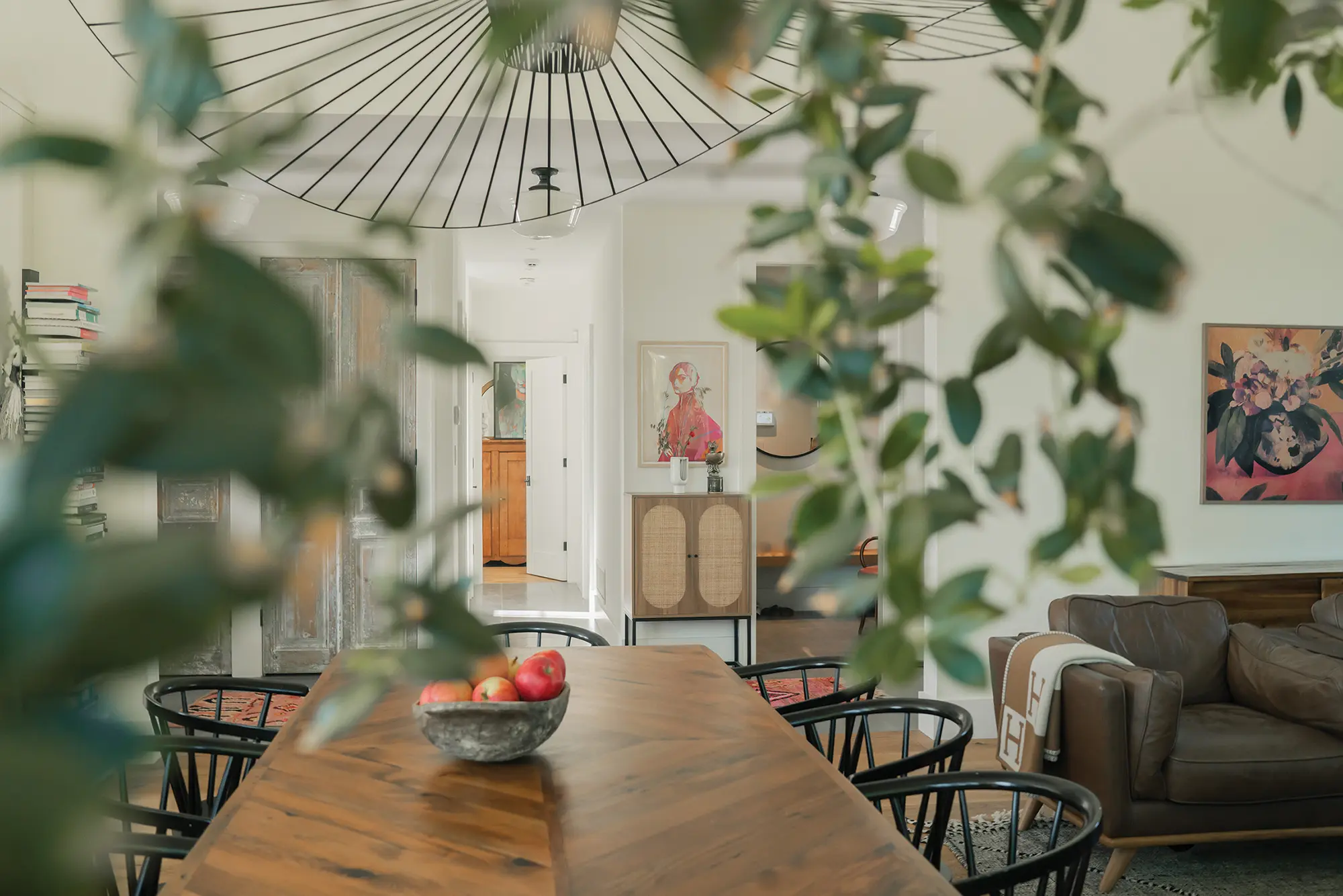 The light-filled entrance hall features antique closet doors from The Door Store. The wood-burning stove was salvaged from the schoolhouse and refinished.